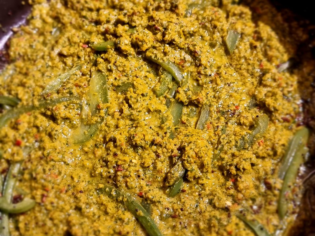 Once the pepper softens, add the curry paste